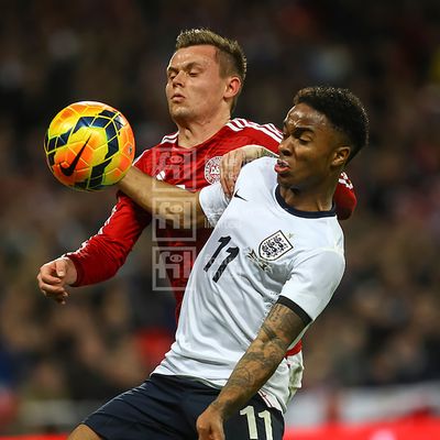 Raheem Sterling shields the ball from Peter Ankersen