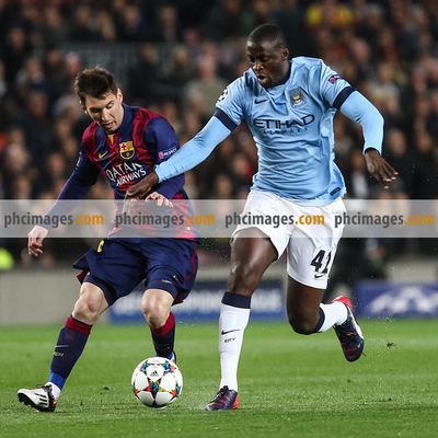Messi and Toure compete for the ball