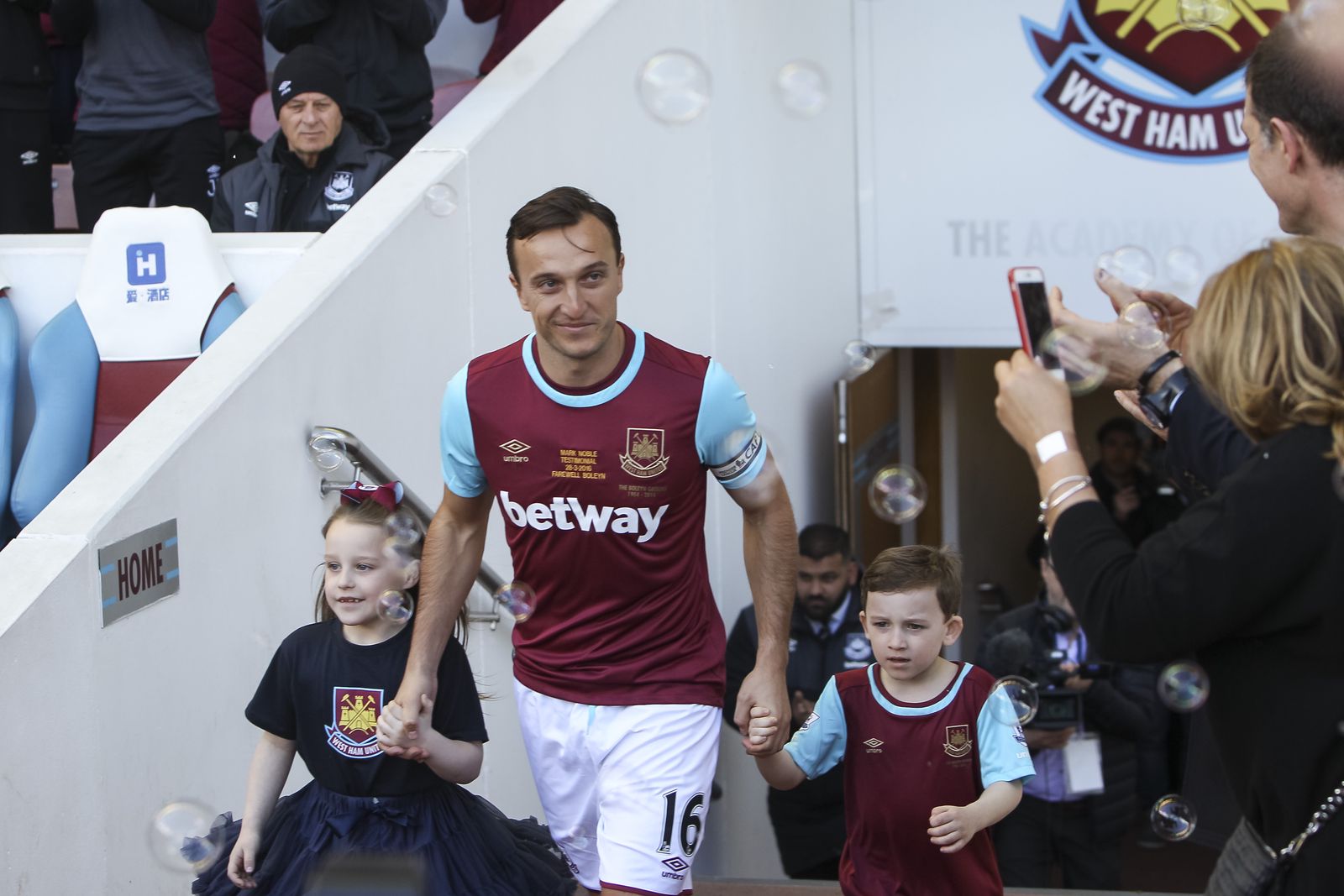 Mark Noble walks out before his testimonial. I feel the photo tells the story quite well: the ‘Home’ sign, his kids, bubbles, and his glance over to his wife and manager Slaven Bilic. (70mm, ISO400, 1/640th, f4)