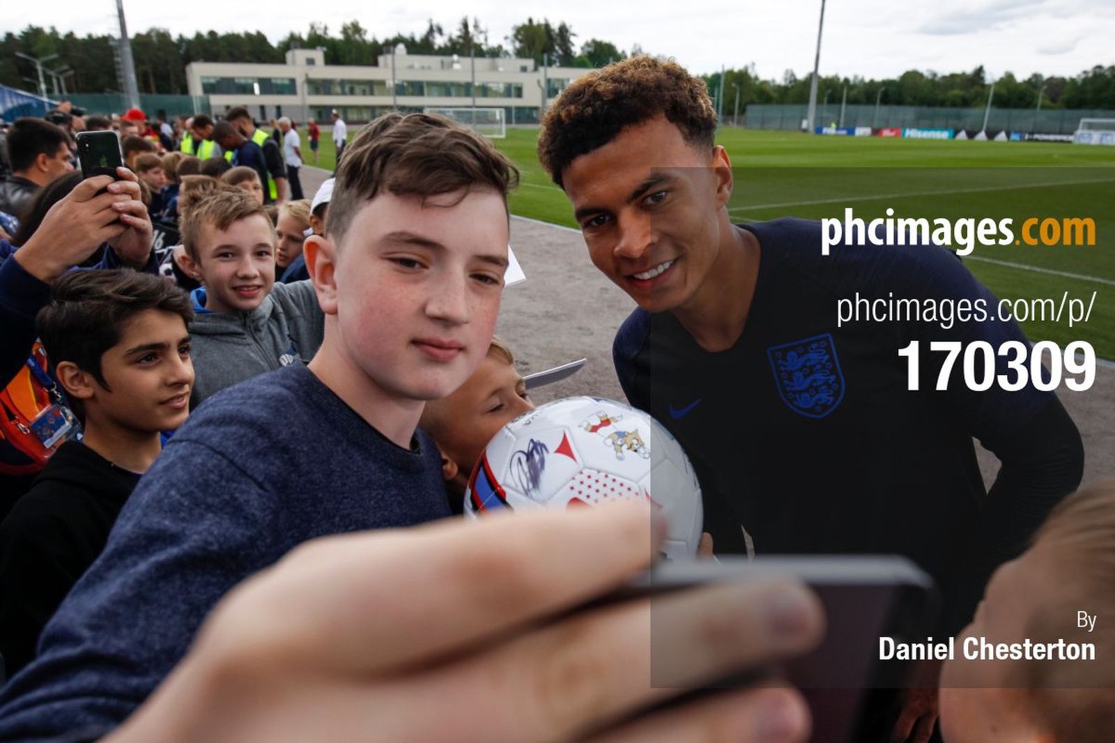 Dele Alli poses for photos with locals after training