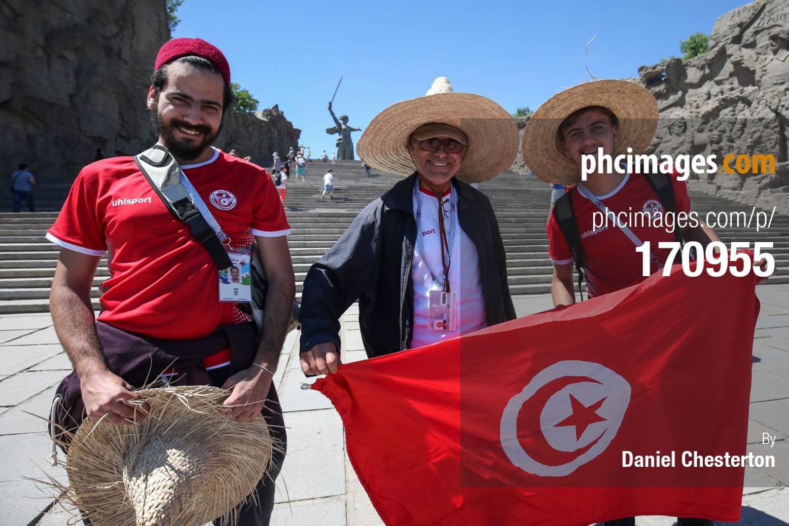Tunisia fans pose for photos in front of the Motherland Calls statue