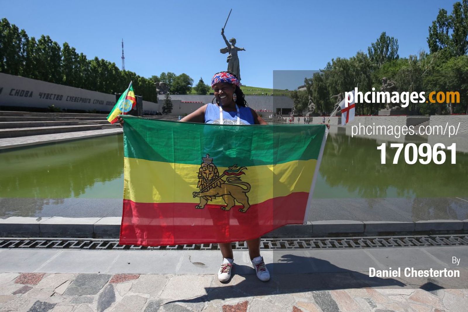 An Ethiopian England fan poses with the Ethiopia flag in front of the Motherland Calls statue