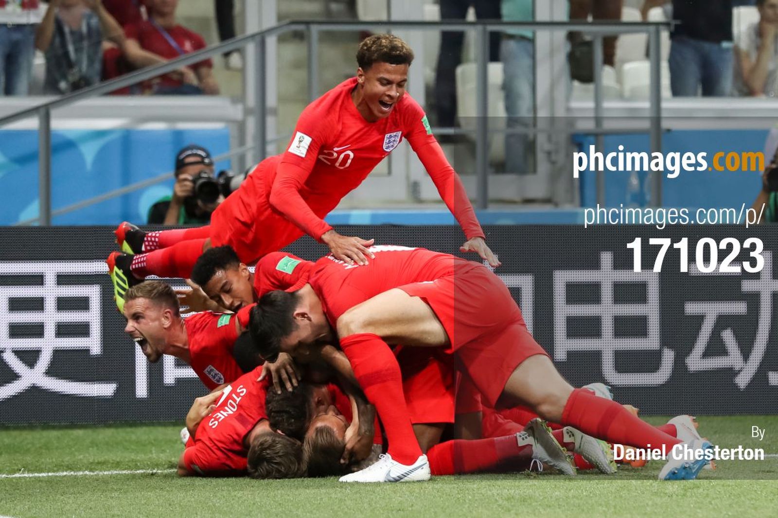 Dele Alli dives on his teammates after the first goal