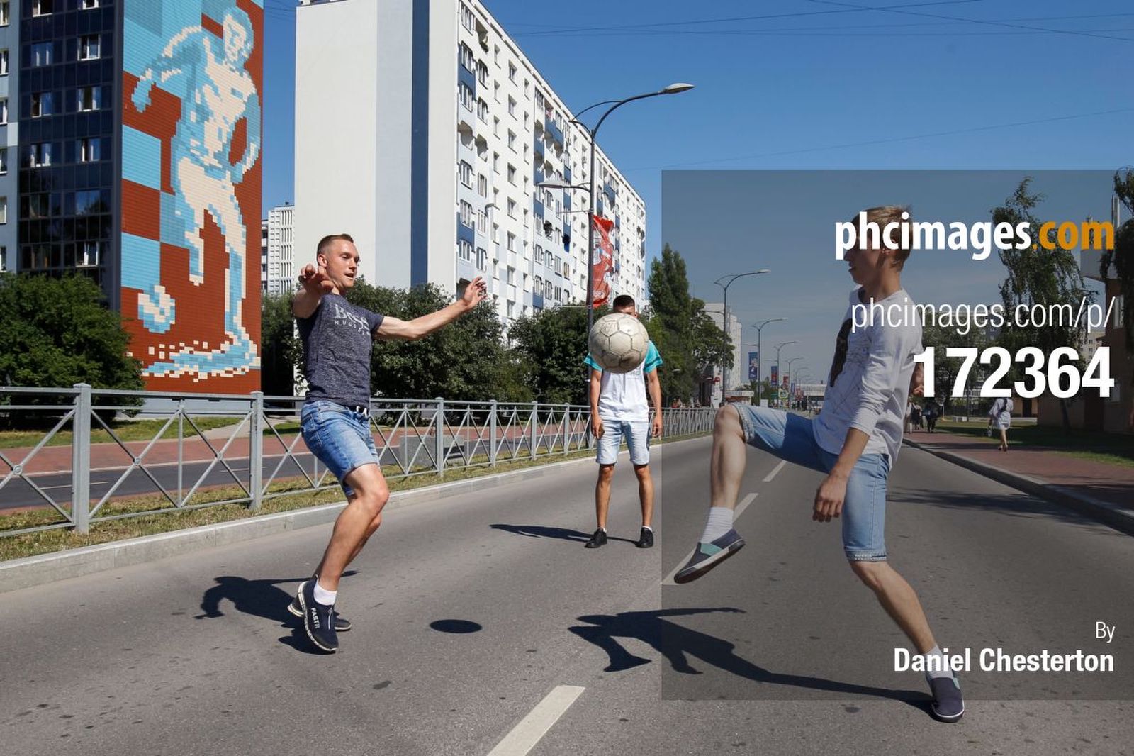 Young Russians play football near the stadium