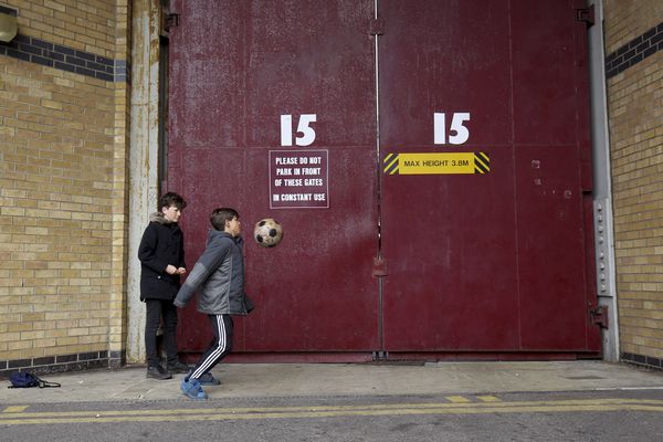 Boys play football outside the ground before a match against Arsenal