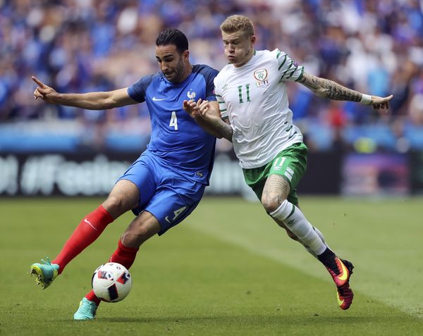 Adil Rami and James McClean compete for the ball