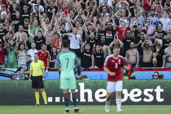 Hungary fans gesture at Cristiano Ronaldo after he misses a free kick