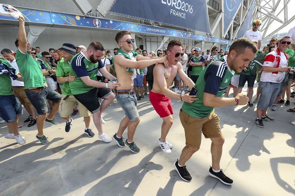 Northern Ireland fans and Poland fans party outside