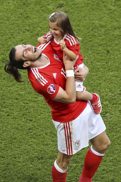 Gareth Bale celebrates with his daughter Alba after beating Northern Ireland
