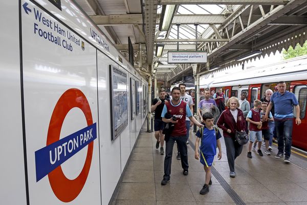Fans leave Upton Park underground station on their way to the stadium