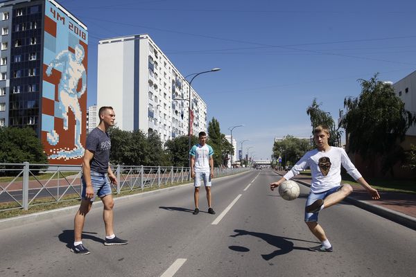 Russian men play football near the stadium in Kaliningrad, Russia