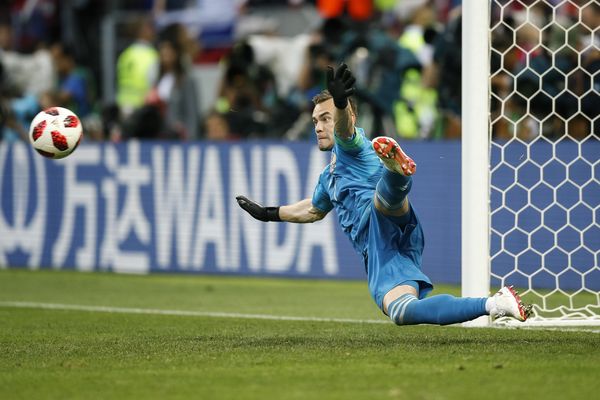 Igor Akinfeev of Russia saves the winning penalty against Spain