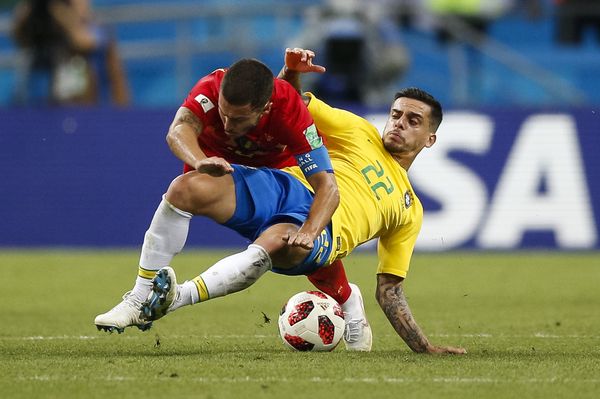 Eden Hazard of Belgium is fouled by Fagner of Brazil