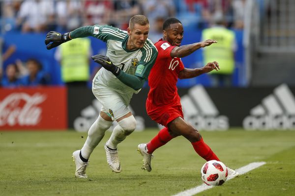 Raheem Sterling of England tries to round Robin Olsen of Sweden