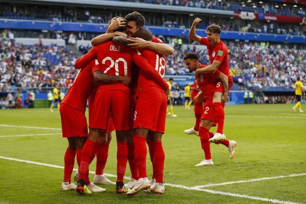 Dele Alli of England celebrates with teammates after scoring against Sweden