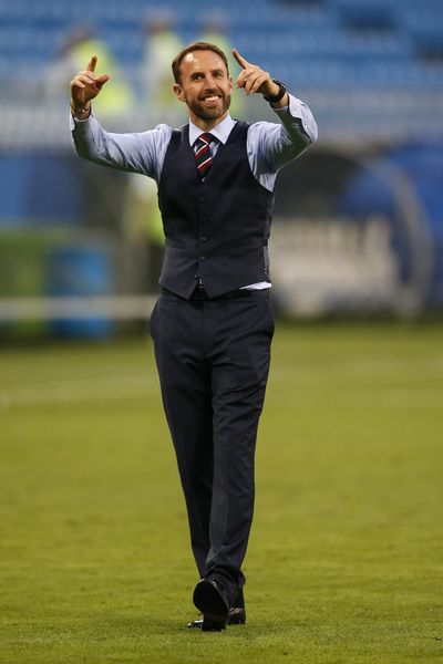England Manager Gareth Southgate celebrates as fans sing his name