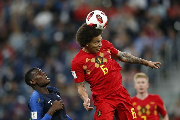 Axel Witsel of Belgium heads the ball watched by Paul Pogba of France