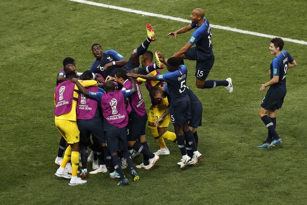 Kylian Mbappe is mobbed after scoring during the World Cup Final