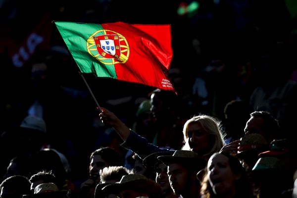 A Portugal fan waves a flag