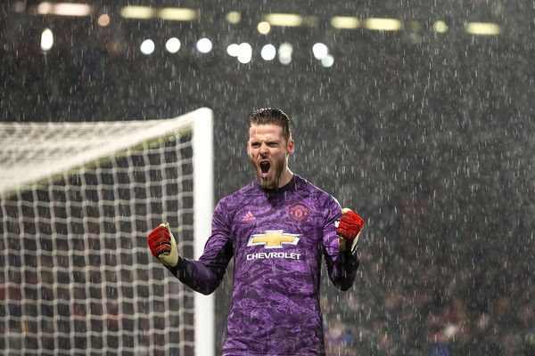 David De Gea celebrates in the rain as Manchester United win the Manchester derby