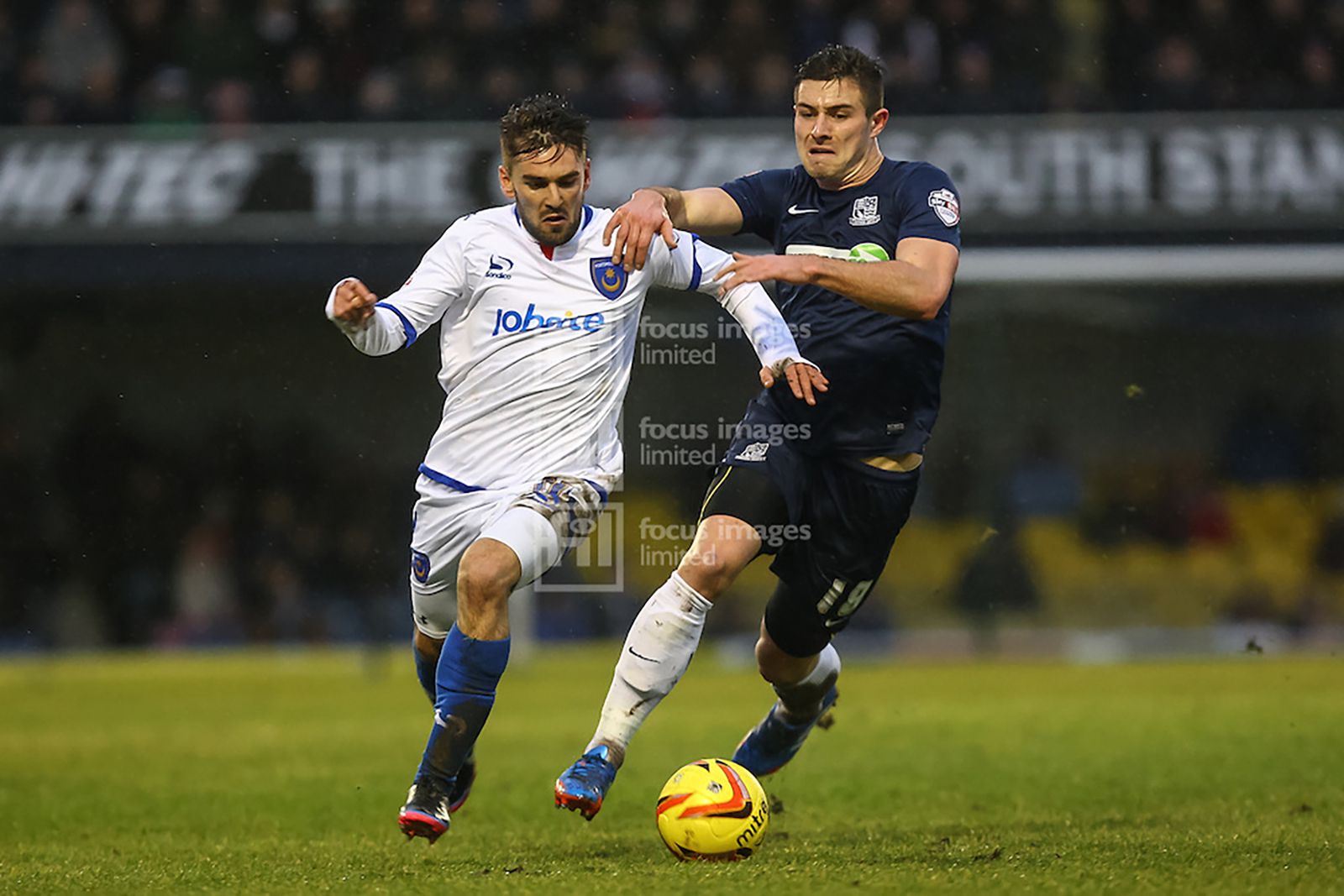 Double goalscorer Ryan Leonard (right) and Ricky Holmes compete for the ball