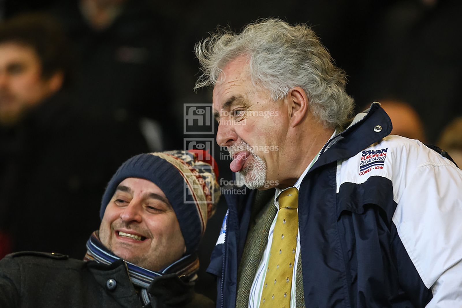 Portsmouth chairman Iain McInnes sticks his tongue out as a fan takes a selfie with him