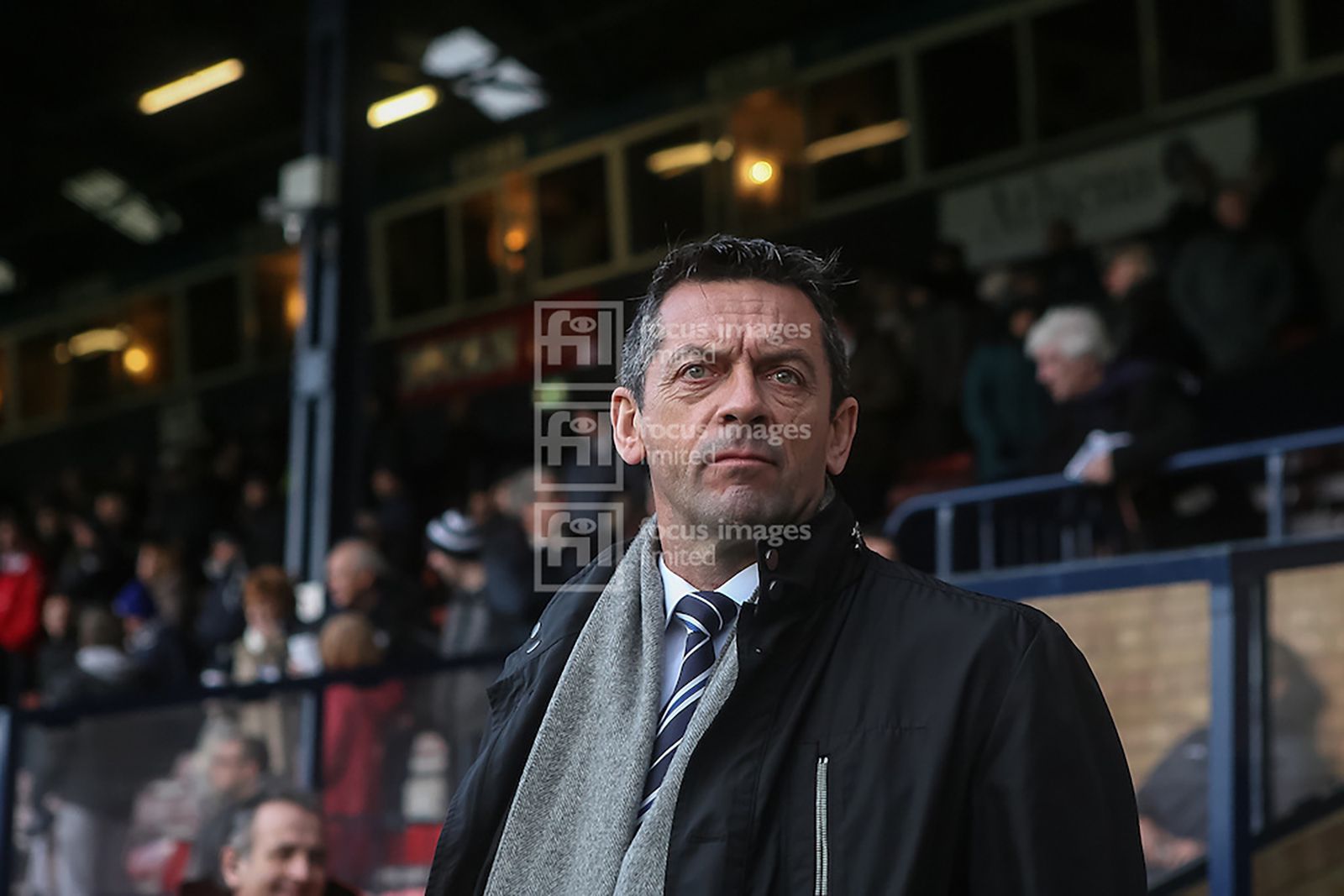 Phil Brown looks on before the match and before the heavens opened