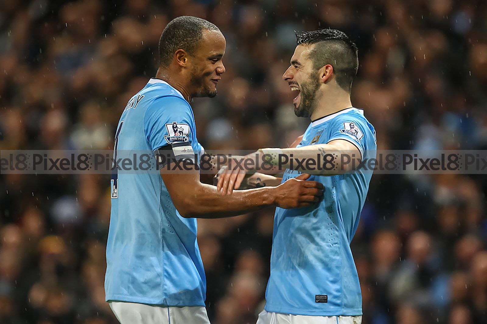 Álvaro Negredo celebrates his second goal with Vincent Kompany