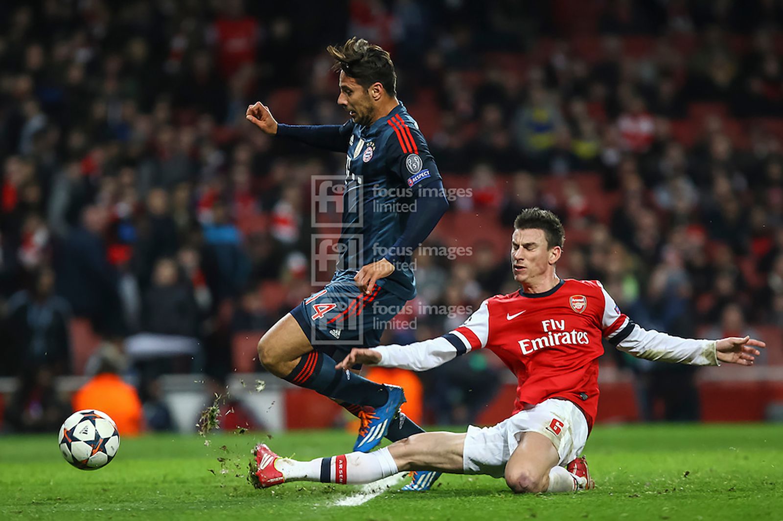 Claudio Pizarro is tackled by Laurent Koscielny