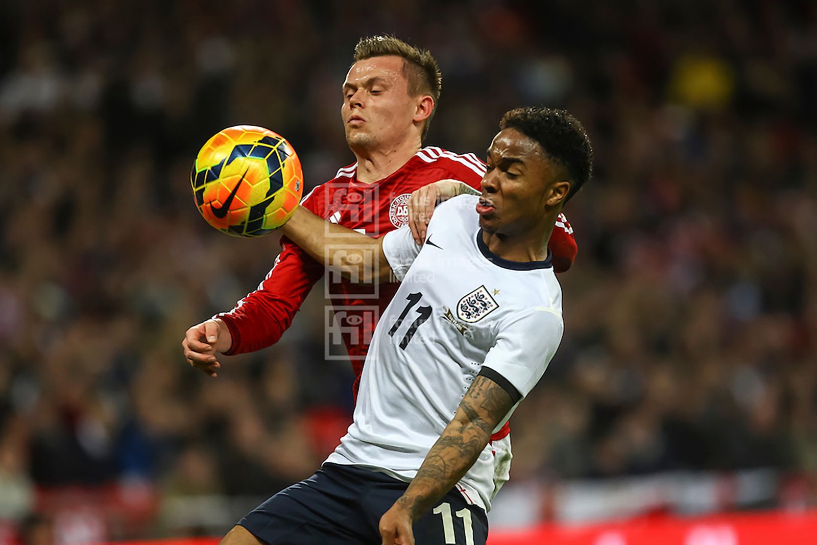 Raheem Sterling shields the ball from Peter Ankersen