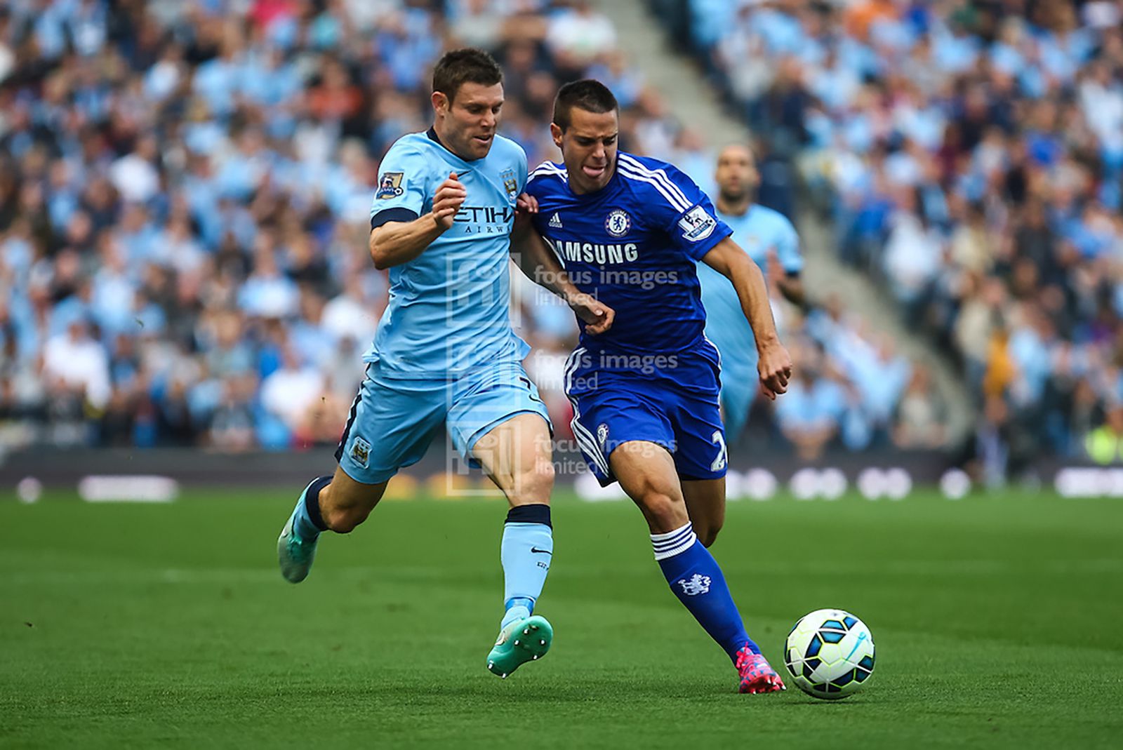 James Milner and César Azpilicueta compete for the ball