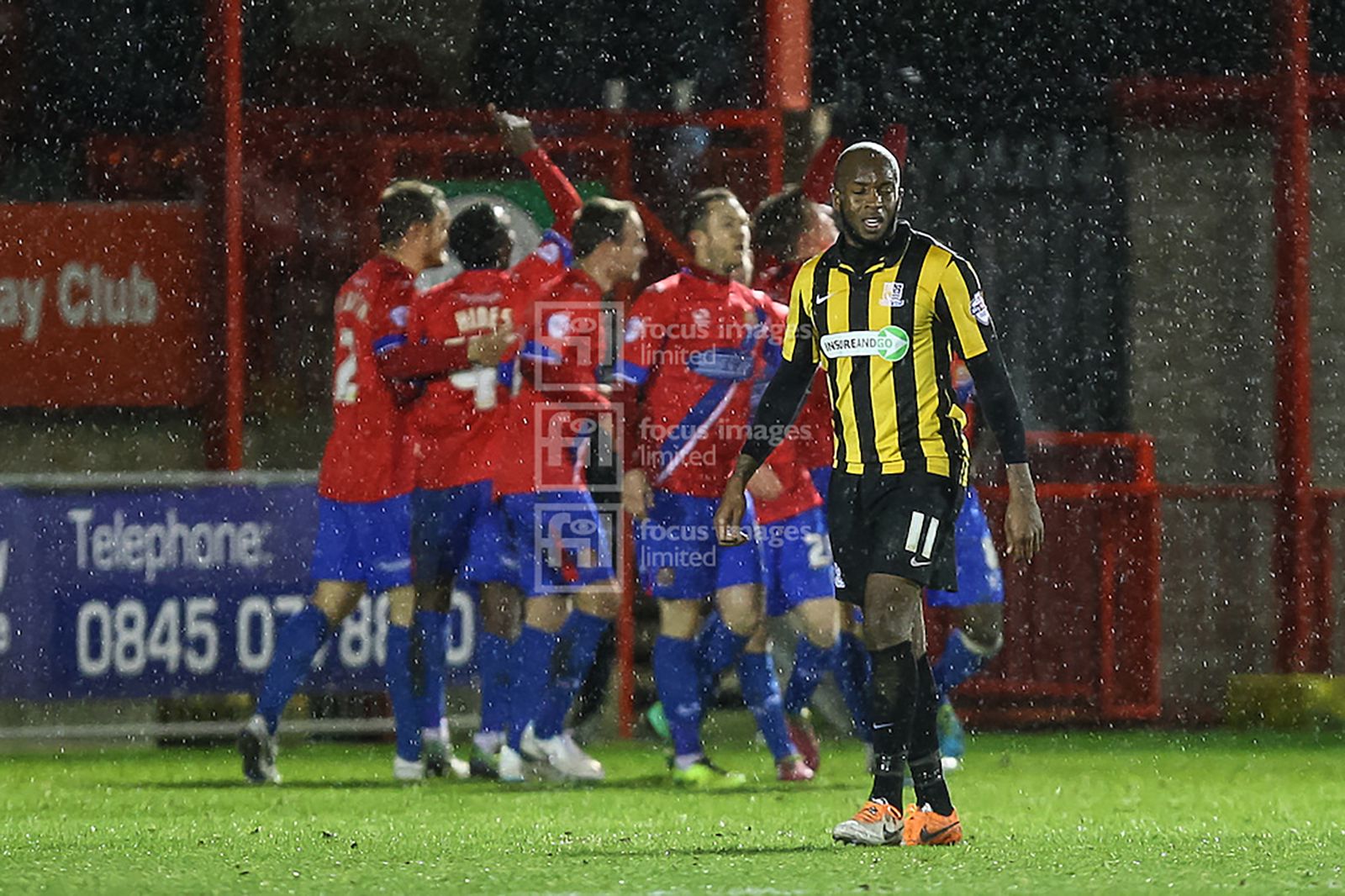 Anthony Straker looks dejected as Dagenham celebrate their goal