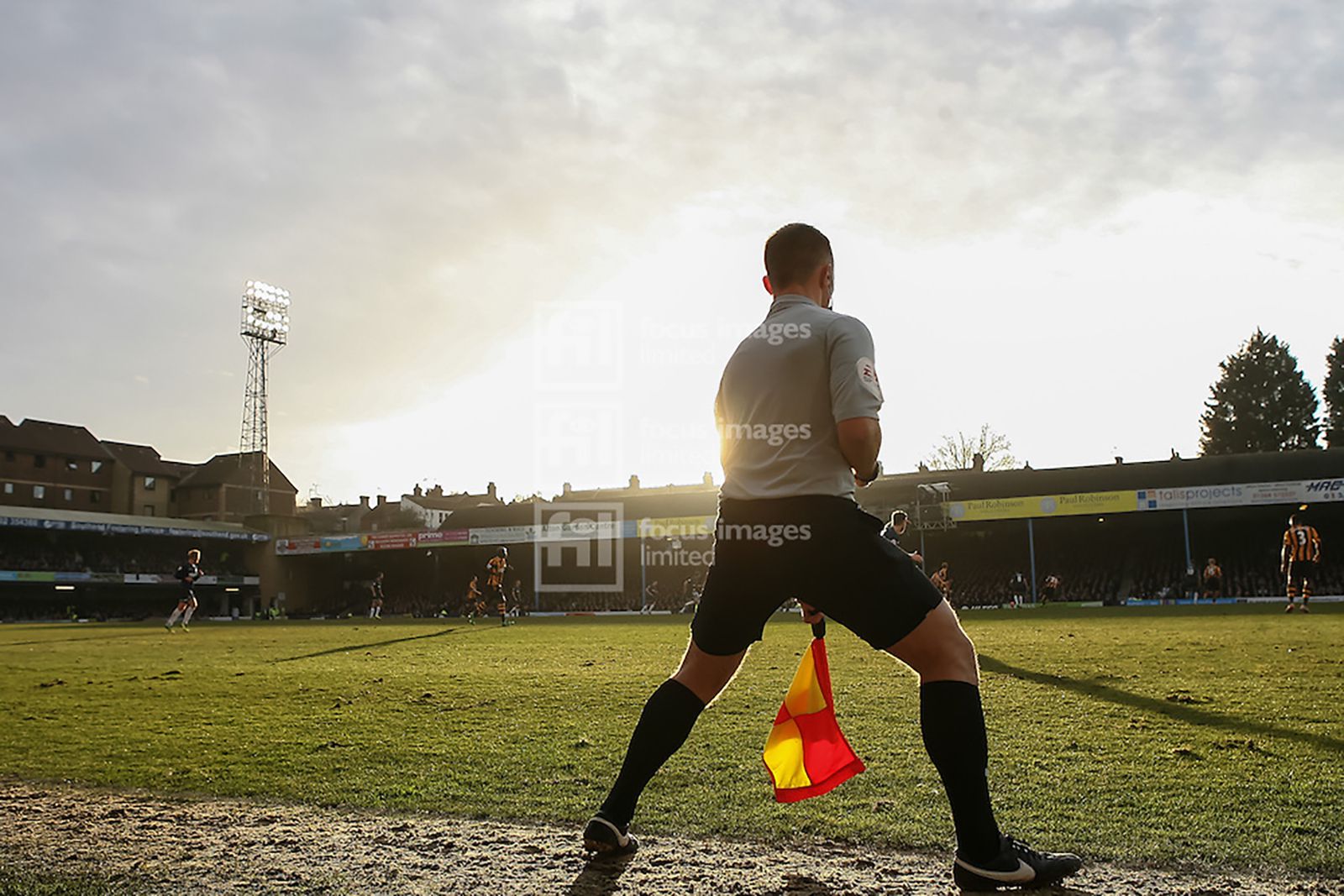 The assistant referee runs the line as the sun sets (just before the heavens opened!)