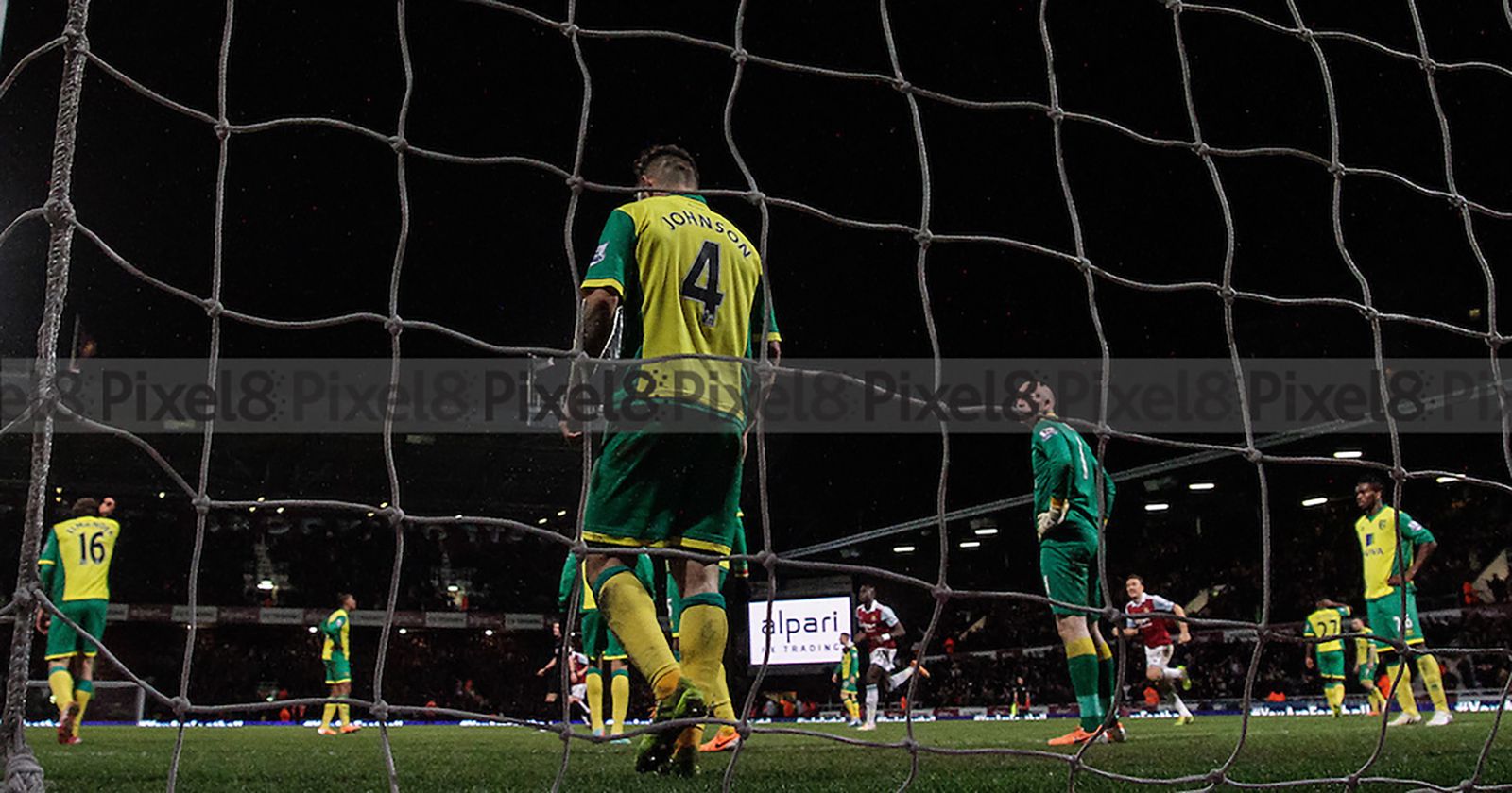 Norwich players look dejected after conceding their first goal as West Ham celebrate