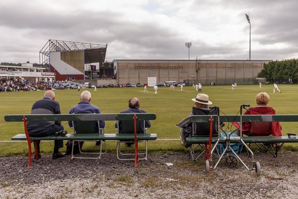 Cricket fans watch the Burnley v Ramsbottom cricket match next to Turf Moor before Burnley v Leeds