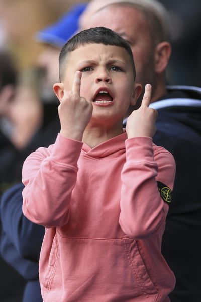 A young Leeds United fan gestures to Crystal Palace fans