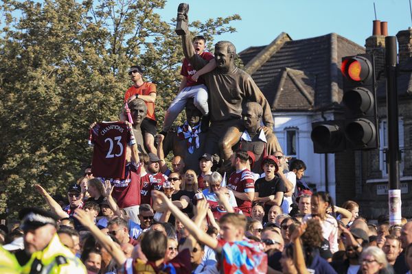 West Ham fans watch from the World Cup winners' statue on Green Street