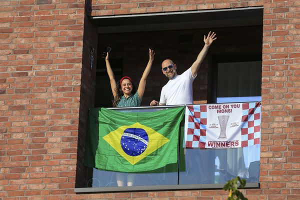 West Ham fans watch on from their apartment window