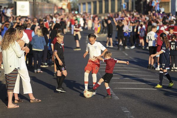 West Ham fans play football as they wait for the parade bus