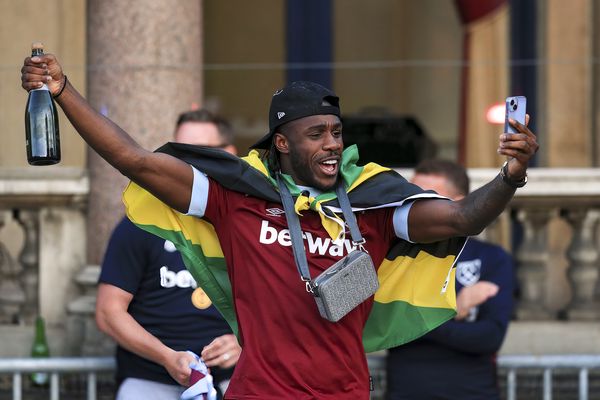 Michail Antonio celebrates with a bottle of alcohol